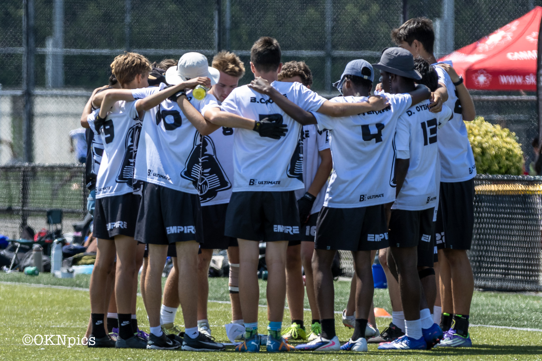 Empire Ultimate players gathered in a team huddle